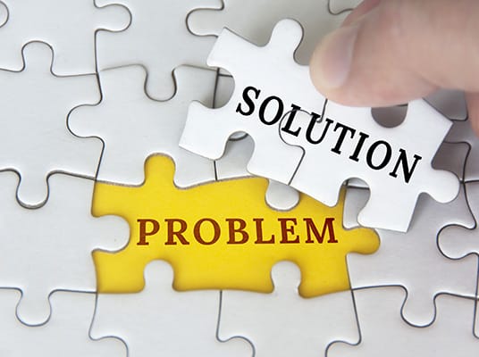 jigsaw puzzle pieces with the words 'problem' and 'solution'